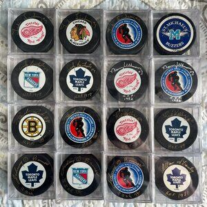 Bundle of 27 vintage autographed hockey pucks
